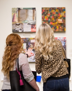 Ashley Motes, left, explains her piece to an attendee during the Brenau Collaborative Opening Reception. (AJ Reynolds/Brenau University)