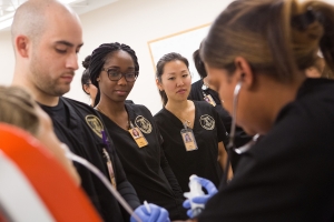 From left, nursing students Richard Gonzalez, Dara Atijosan and Jane Lim look on while Shemila Thompson practices nasogastric tube placement during a skills lab at Brenau East. (AJ Reynolds/Brenau University)