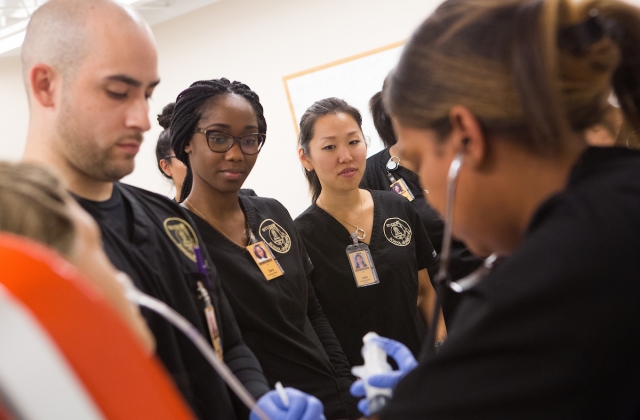 From left, nursing students Richard Gonzalez, Dara Atijosan and Jane Lim look on while Shemila Thompson practices nasogastric tube placement during a skills lab at Brenau East. (AJ Reynolds/Brenau University)
