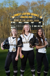 From left to right Mason Garland, a junior from Hoschton, Ga., Eli Daniel, a freshman from Locust Grove, Ga., and Mackenzie Oliver Mullis, a senior from Carnesville, Ga., pose for a photo at Pacolet Milliken Field at the Ernest Ledford Grindle Athletics Park. (AJ Reynolds/Brenau University)