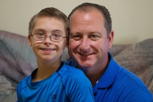 Randal Robison with his 13-year-old son Nolen at their home in Cumming, Ga. Robison is pursing a MAT degree after 21 years as a chaplain in the U.S. Army (AJ Reynolds/Brenau University)