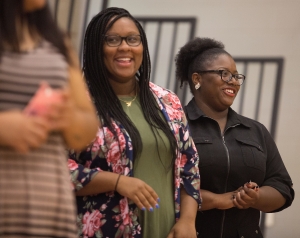Sasha Stovall, WC '15, left, and Chelsey Brown, WC '16, react during the commencement ceremony for the RISE Program on Friday, July 14, 2017 at Fair Street School. (AJ Reynolds/Brenau University)