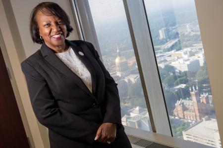 LaSharn Hughes, executive director of the Georgia Board for Physician Workforce, BU '98, BU '04 poses for a photo with the Georgia State Capital in the background at her office in Atlanta. (AJ Reynolds/Brenau University)