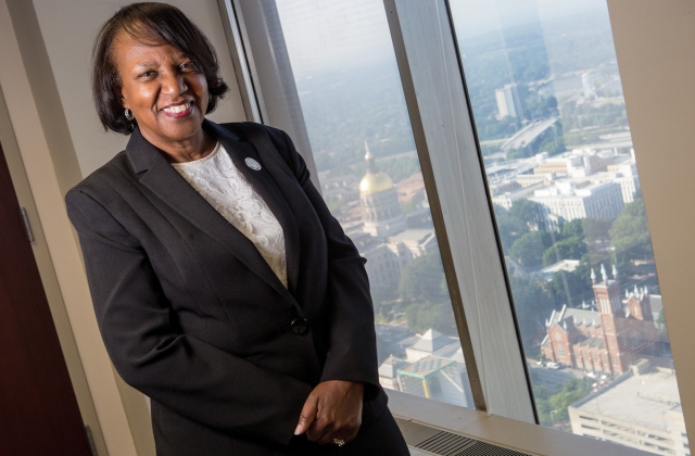 LaSharn Hughes, executive director of the Georgia Board for Physician Workforce, BU '98, BU '04 poses for a photo with the Georgia State Capital in the background at her office in Atlanta. (AJ Reynolds/Brenau University)