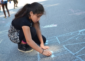 Irais Carlin draws with sidewalk chalk during the RISE Summer Program. RISE, or the Real, Interactive, Summer-Learning Experience, ran from June 5, 2017 through July 14, 2017.