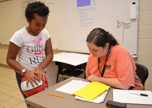 Aalliyah Glasper, left, discusses a story she wrote with her teacher in the RISE Summer Program, Bri Neves.