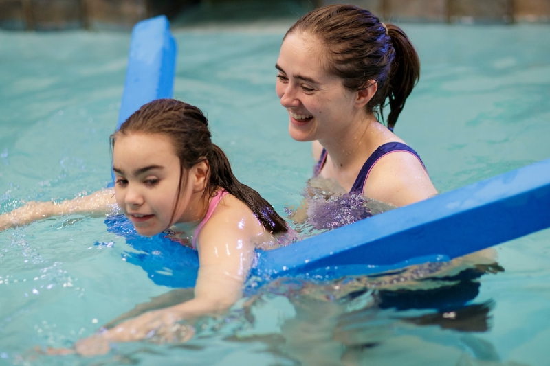 Emily Moss, BU '16, occupational therapist at Walker Therapy, works with a client in an aquatic therapy session. (AJ Reynolds/Brenau University)