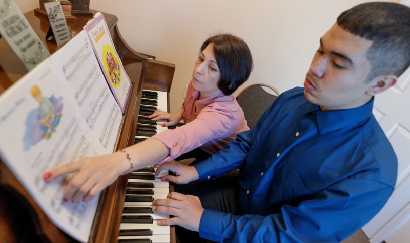 Olesya Sypchenko teaches a music lesson to a student with autism at Sound of Music school in Buford, Ga. (AJ Reynolds/Brenau University)