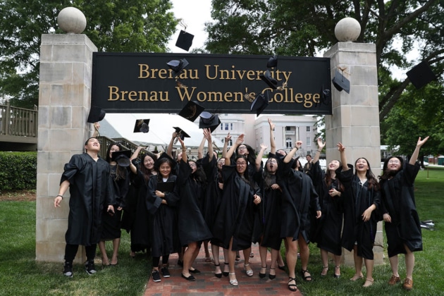 ANU-Brenau University students throw their mortarboard into the air Saturday May 5, 2018 in Gainesville, Ga. (Jason Getz for Brenau University)